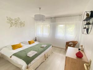 a bedroom with a large bed with yellow and green sheets at Le coteau in Le Palais