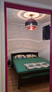 a bedroom with a bed with a chandelier above it at Arabeska Majeli in Rukavac