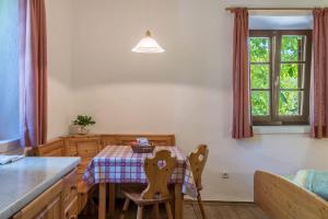 a kitchen with a table and chairs and a window at Sallrain Hof Monolokal 4 in Collalbo +14 photos