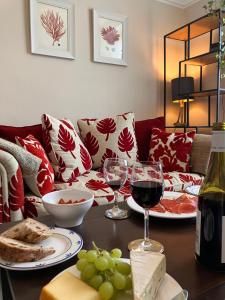 a table topped with glasses of wine and plates of food at Elegant well appointed maisonette 105m2 in Bath