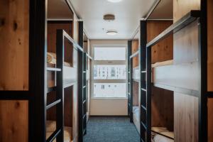 a room with a bunk bed and a window at Kinship Landing in Colorado Springs