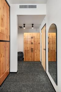 a hallway with wooden doors and a mirror at Kinship Landing in Colorado Springs