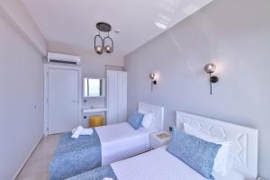 a bedroom with two beds with blue pillows at Mare Vista Apart in Kaş