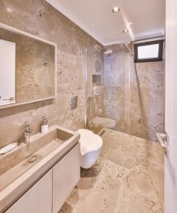 a bathroom with a sink and a toilet and a shower at Mare Vista Apart in Kaş +33 photos