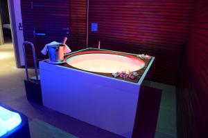 a bath tub in a bathroom with a sink at Hotel Mirasole International in Gaeta