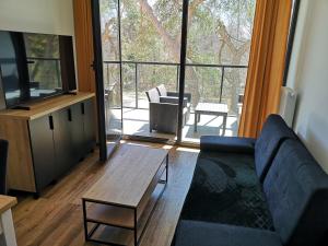 a living room with a couch and a large window at Apartament Dorka in Rogowo