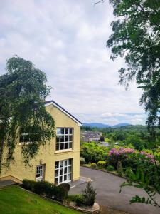 a yellow house with a view of the countryside at Spring Grove Guesthouse in Donegal