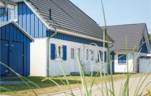 a house with blue and white paint on it at Ferienhaus 3 Altefähr in Altefähr +23 photos
