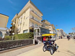 a group of people riding a motorcycle with an umbrella at Hotel Morri in Bellaria-Igea Marina