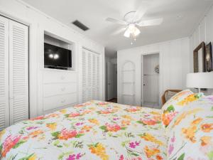 a bedroom with a bed and a ceiling fan at Cozy Cottage in Flagler Beach