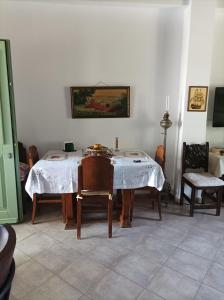 a dining room with a table and two chairs at The house in the port in Korissia