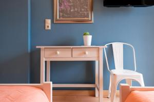 a desk and a chair in a room with a wall at Dimitra's Garden - Holiday Apartments in Parga