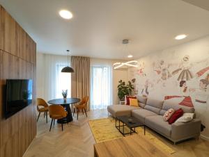a living room with a couch and a table at [VerdeS] - Joyride Exclusive Apartment in Oradea