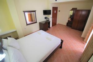 Postel nebo postele na pokoji v ubytování Oskar Hotel