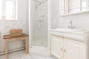 y baño blanco con lavabo y ducha. en Coachella Vintage Chic in the Heart of St Charles Biarritz en Biarritz
