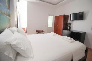 Postel nebo postele na pokoji v ubytování Oskar Hotel