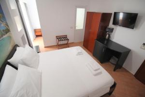 Postel nebo postele na pokoji v ubytování Oskar Hotel