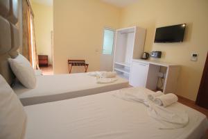 Postel nebo postele na pokoji v ubytování Oskar Hotel