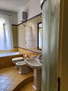 a bathroom with two toilets and a sink at B&B Marìsicilia in Porto Empedocle