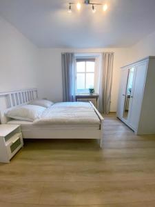 a bedroom with a white bed and a window at Herbeder Straße in Witten