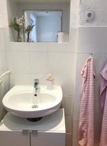 a white bathroom with a sink and a mirror at Herbeder Straße in Witten