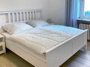 a white bed in a room with a window at Herbeder Straße in Witten