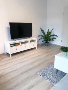 a living room with a flat screen tv on a white cabinet at Herbeder Straße in Witten