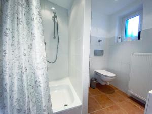 a bathroom with a shower curtain and a toilet at Herbeder Straße in Witten