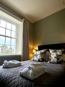 a bedroom with a bed with two towels on it at Dovenby Apartment- great base for exploring Lake District in Cockermouth
