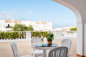 a table and chairs on a balcony with a view at Apartamento CASTELLSOL 309 by Mauter Villas in Arenal d'en Castell