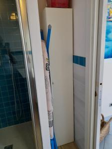 a bathroom with two baseball bats leaning against a wall at Excelsior Mare Suite in Ischia