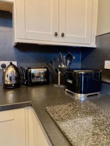 a kitchen counter top with a toaster and a toasterrences at Dovenby Apartment- great base for exploring Lake District in Cockermouth