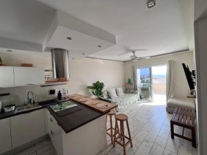 a kitchen and a living room with a couch at New Deluxe Stunned Seaview 2 bed Apt in Adeje
