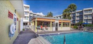 a swimming pool in front of a apartment building at Amazing Waterfront Views Resort, Enjoy Heated Pool & Sunset! in Tampa