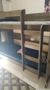 a wooden bunk bed with a ladder in a room at Dom Antonio 3 in Campos dos Goytacazes