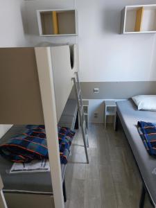 a small room with two bunk beds and a ladder at CARNAC Mobil-Home Camping 4 étoiles in Carnac