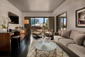 a living room with a couch and a table at SIXTY Beverly Hills in Los Angeles