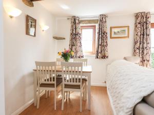a bedroom with a table and chairs and a bed at Top House in Settle