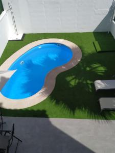a swimming pool with a path around it at Casa Cristy in Montejaque