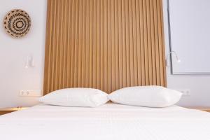 A bed or beds in a room at Dimani Suites
