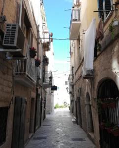 an alley in an old town with buildings at Maison de Marie in Trani
