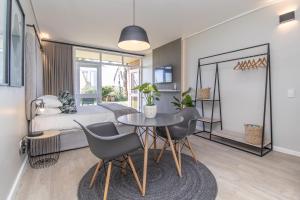 a bedroom with a bed and a table and chairs at 36 At Brookes in Summerstrand