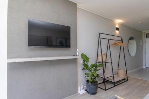 a living room with a flat screen tv on a wall at 36 At Brookes in Summerstrand