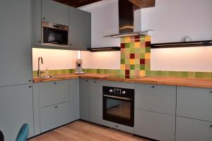 a kitchen with white cabinets and a stove top oven at Chez Daniel in Vauclaix