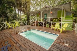 a house with a swimming pool on a wooden deck at Lovely Casa Cucula Pool House with FiberOp in Cocles