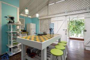 a kitchen with a checkered table and stools at Lovely Casa Cucula Pool House with FiberOp in Cocles