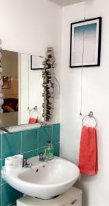 a bathroom with a white sink and a mirror at Lovely 2 Bed Flat/Apt in East London- Nice Estate. in Dagenham