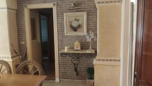 a room with a brick wall with a table and a door at Apartamento en Torremolinos in Torremolinos