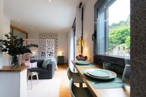a living room with a table with plates on it at Loft Ladeira Real in Baiona
