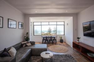 a living room with a couch and a table at Cremorne on Beach Road in Summerstrand